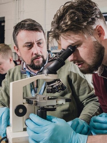 Man using microscope