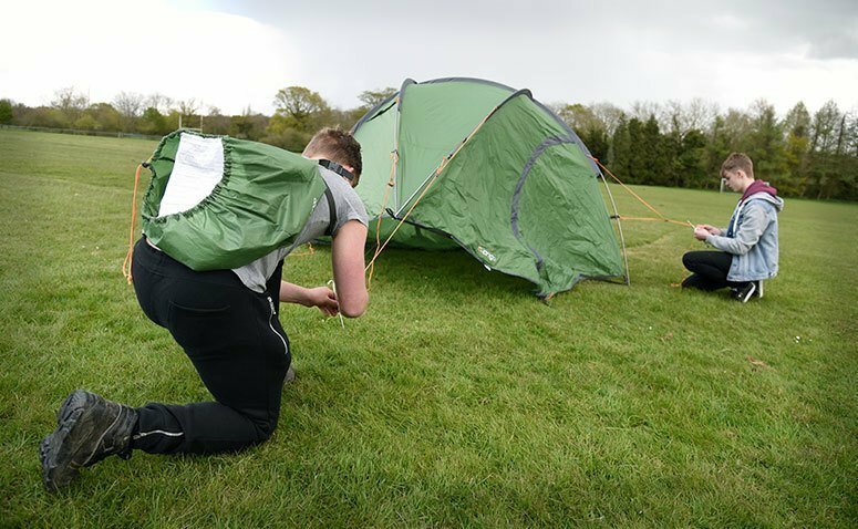 Students setting up a tent