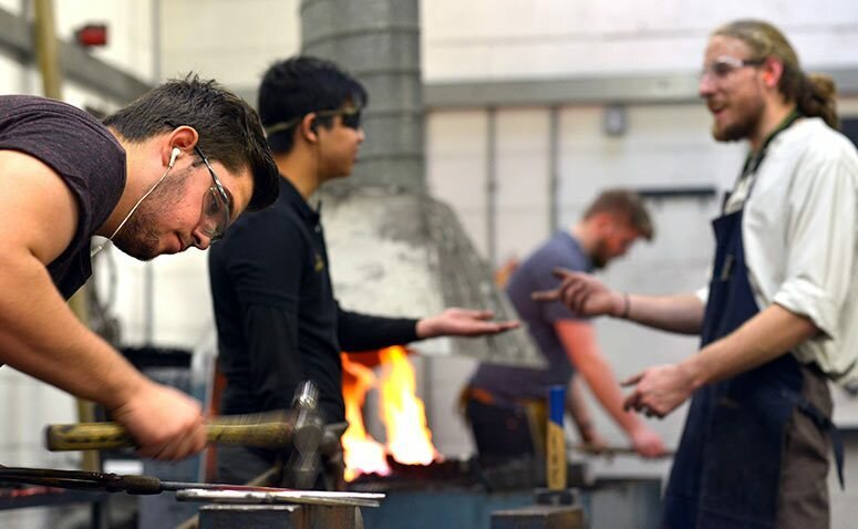 Group of student metalsmithing