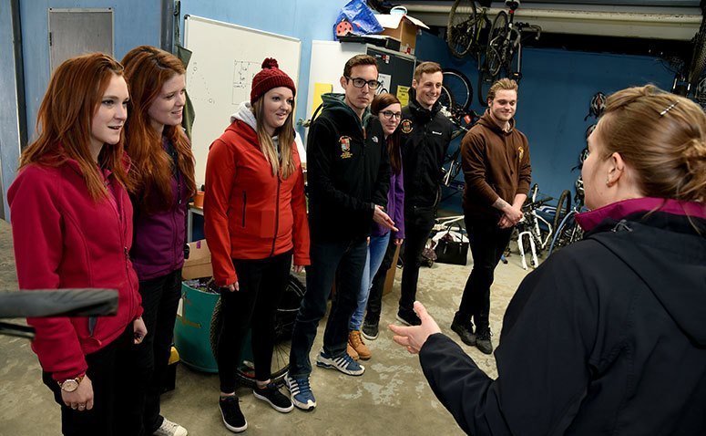 A group of student getting a briefing