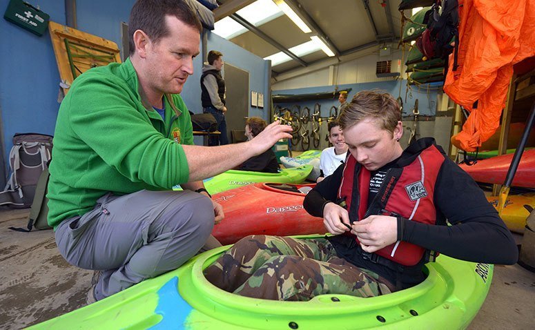 A student putting on a life jacket