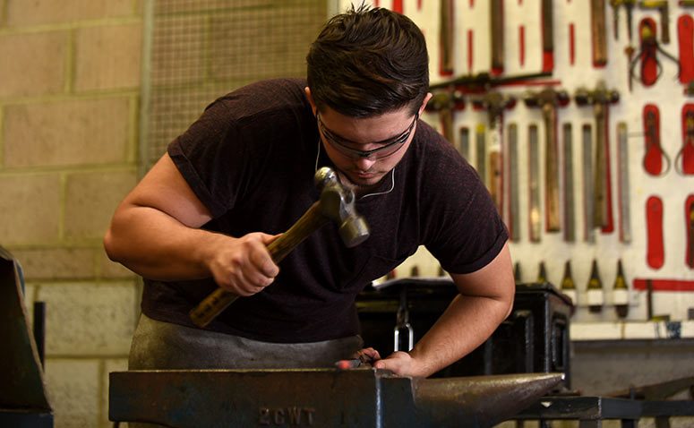 Student working on an anvil