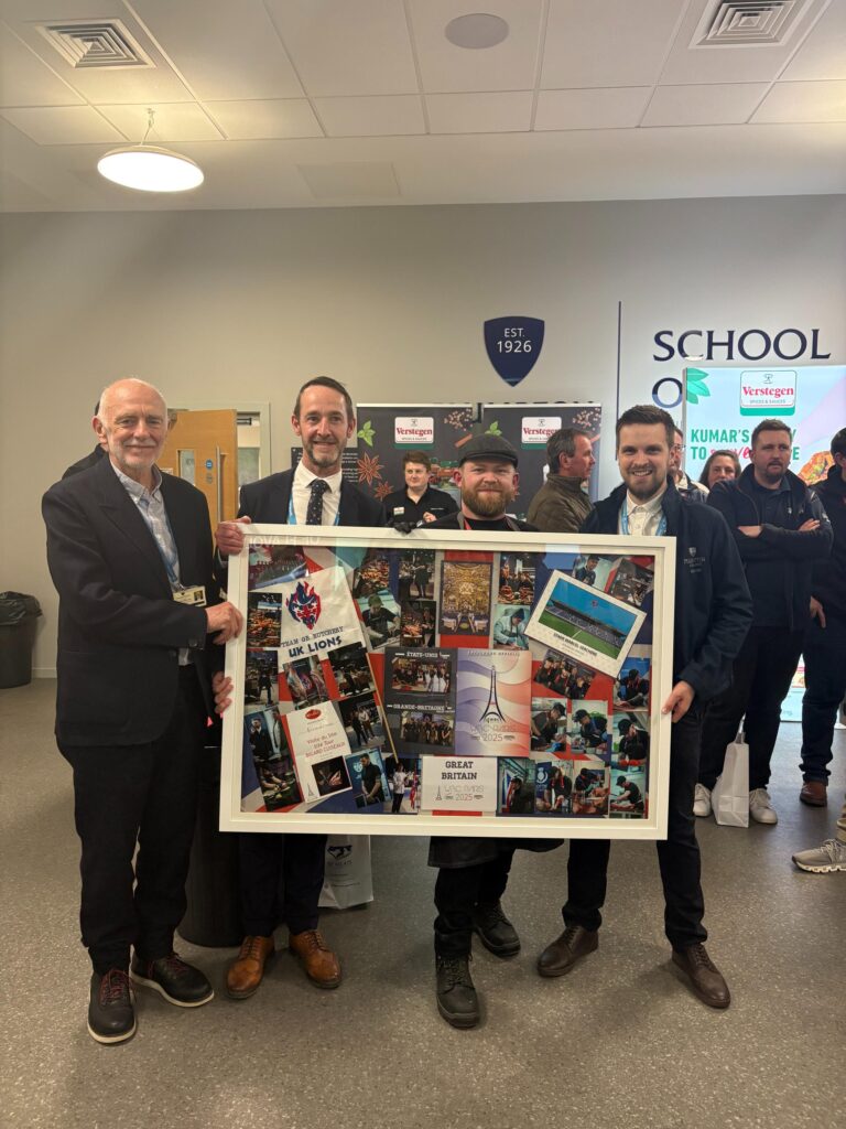 Four men hold a framed photo collage marking Team GB Butchery's UK Lions at the WBC Paris 2025 competition